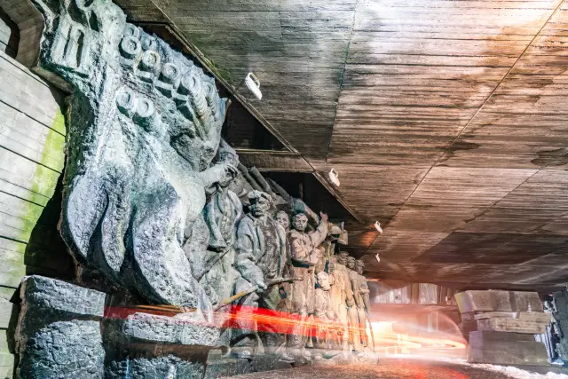 A long-exposure light streak passing carved reliefs inside a dim stone temple