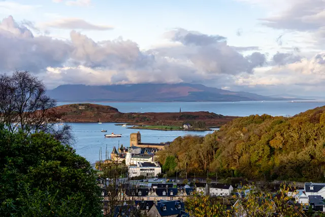 A view over a Scottish coastline with islands and hills.