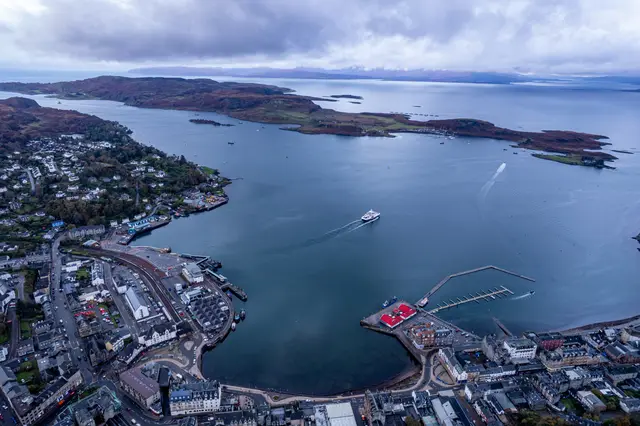 An aerial view of a Scottish coastal town and its harbour.